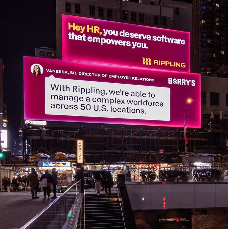 Photograph of a billboard with the Rippling logo that says, "Hey HR, you deserve software that empowers you" over a billboard with the Barry's logo and quote from Vanessa, Sr. Director of Employee Relations, that says, "With Rippling, we're able to manage a complex workforce across 50 U.S. locations"