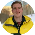 Tiny circular portrait of a person in a yellow jacket outdoors