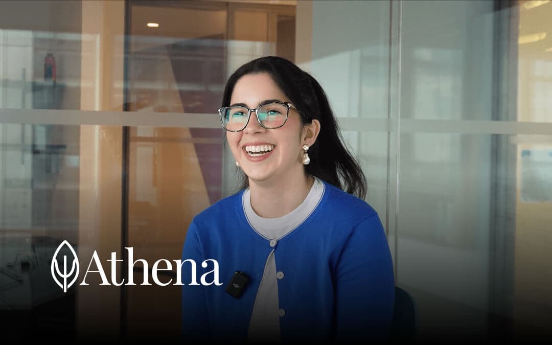 Smiling person with glasses in a blue cardigan, with “Athena” text below.